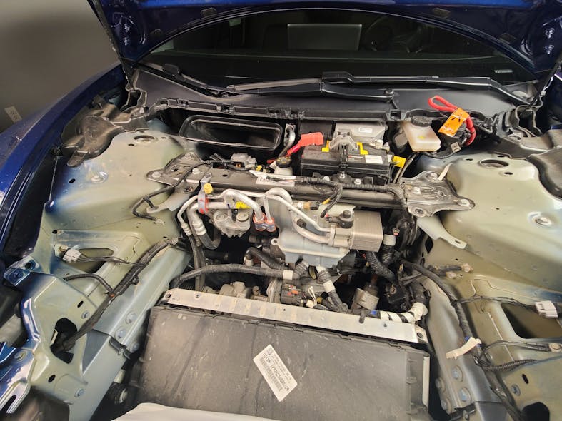 You can clearly see the low voltage 12-volt lead acid battery on this under-trunk view of a Tesla.